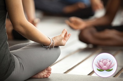 Cropped image shows women seated cross-legged in yoga-like pose. A graphic of a lotus flower is shown in corner of photo.